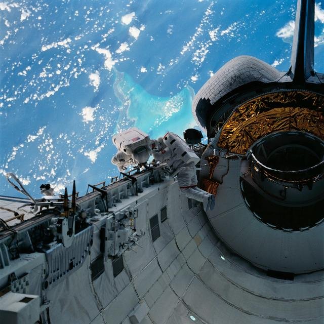 Astronauts Newman and Walz evaluate tools for use on HST servicing mission