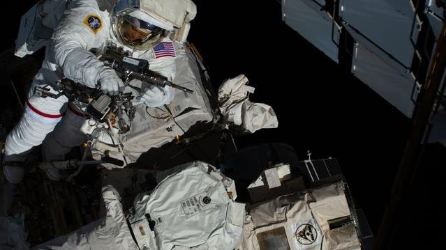 NASA astronaut Chris Williams uses a pistol grip tool during a spacewalk